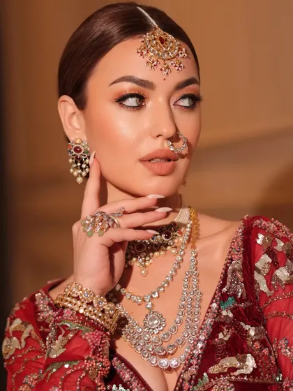 Presenting the Rivayat look. A close-up on the stunning jewelry and the bride's elegant expression.