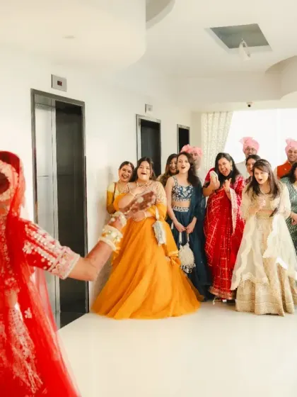 The bride reveals her final look to her bridesmaids, and their expressions of awe and joy are priceless. This is a perfect "first look" moment with the bride tribe.