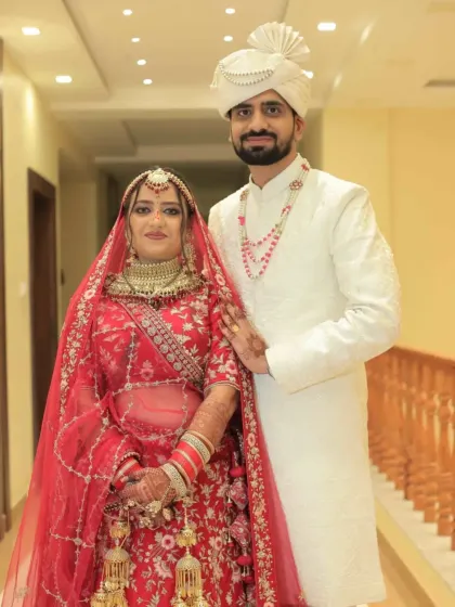 A wedding portrait of Deepak and Akshita. Both devoted to the path of wisdom and growth, they found a shared purpose through our matrimony service, bridging their backgrounds in engineering and research.