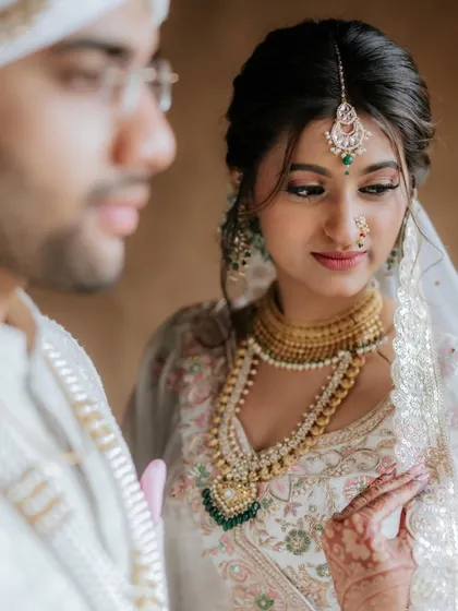 A close up of the bride looking at her groom. Her makeup is subtle, with a focus on glowing skin and defined eyes.