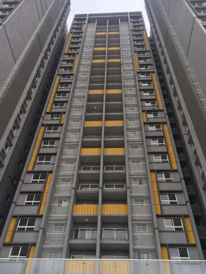 The facade of the Salarpuria Sattva Opus residential tower, where we used a bold color scheme of grey and yellow to create a modern and energetic architectural statement.