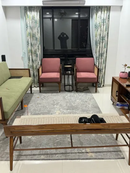 A full view of a client's living room, featuring my custom-made mid-century furniture. The set includes a sofa and two armchairs with cane details, a slatted-front media console, and a woven-top coffee table, creating a harmonious and stylish look.