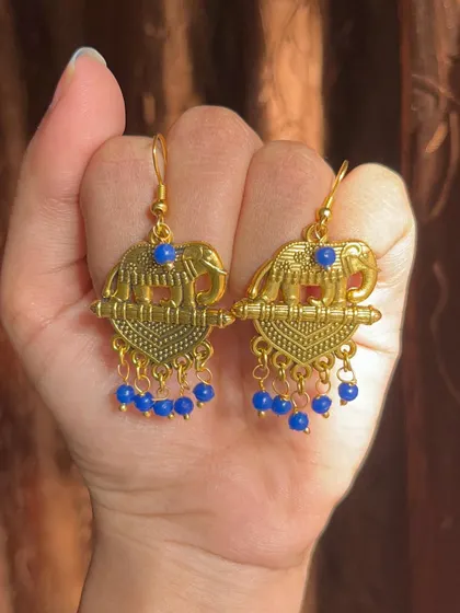 These gold-oxidised earrings feature a lovely elephant motif with dangling blue beads. They are a unique and affordable accessory for daily wear.
