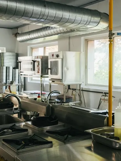 The professional kitchen at our Domlur academy, fully equipped with commercial-grade stoves, ovens, and workstations for our students.