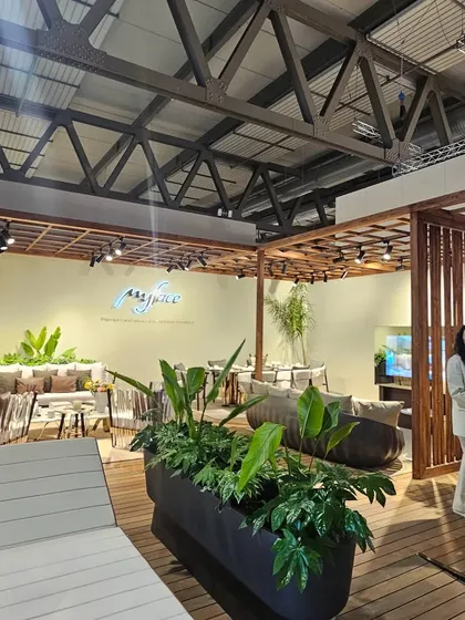 A wide shot of one of our spacious and airy showroom displays. The combination of wooden decking, lush planters, and comfortable seating creates an inviting atmosphere.