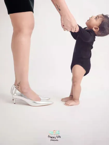 A baby looking up at his mother, holding her hand. This simple, minimalist photo powerfully captures a baby's trust and a mother's guidance.