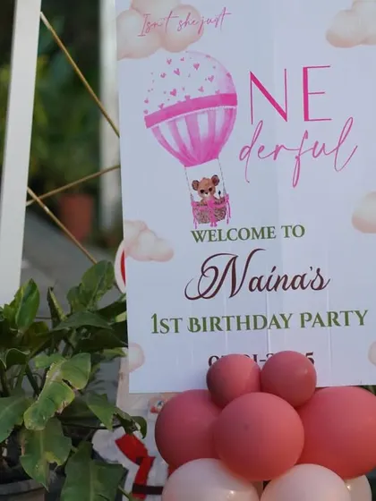 A "ONE-derful" welcome board for a hot air balloon themed first birthday party. The cute graphics and personalized text make it a sweet addition to the entrance decor.