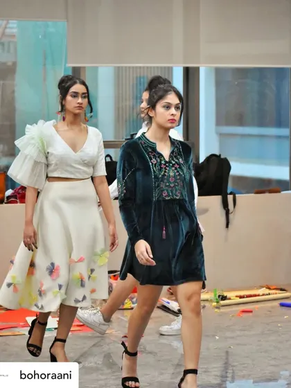 Models on the runway during our showcase at the Tvaran Fest. The look on the left features our ruffled sleeve top with a floral applique skirt, while the right shows a velvet embroidered tunic dress.