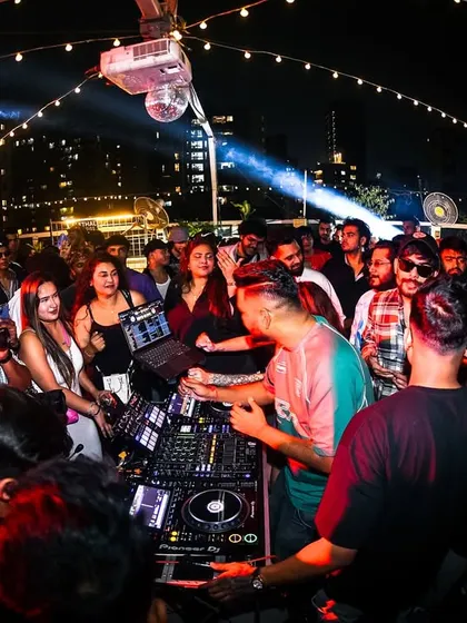 The crowd surrounding the DJ booth at the Block Party. The energy is tangible when you're this close to the action.