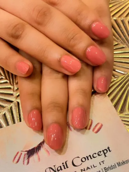 A simple and pretty set of short, natural nails in a peachy-pink color. This is a great option for a low-maintenance, polished look.