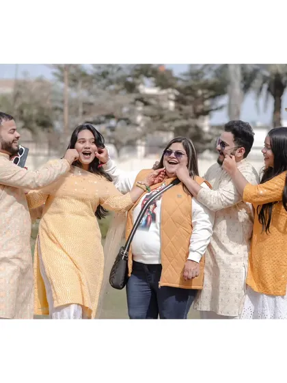 A playful and candid moment between friends at a Haldi ceremony. These are the unscripted memories that truly tell the story of your day.