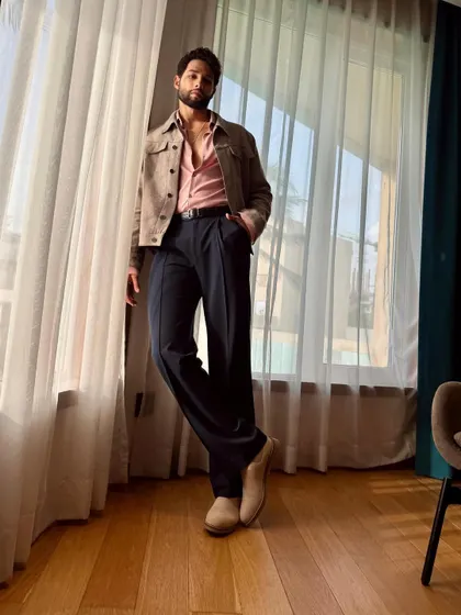 The full-length view of Siddhant's outfit. The wide-leg trousers and casual jacket create a relaxed yet polished silhouette.