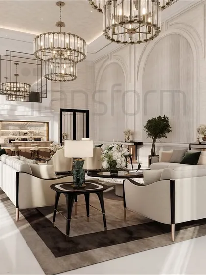 This modern classic living area extends from the entrance, featuring grand chandeliers and stone-clad archways that echo timeless strength. The space is designed as an expanse of comfort and whispered sophistication.