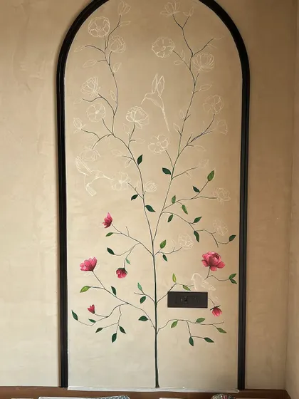 This shows the mural in progress. I started with a white chalk outline to map the design, then began adding the delicate pink flowers and green leaves, bringing the branches to life.