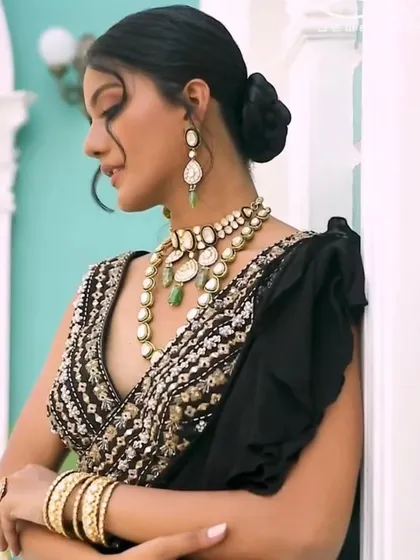This shot captures the full elegance of the polki set and ruffled black saree. The pose and composition were designed to showcase how the jewelry moves and catches the light.
