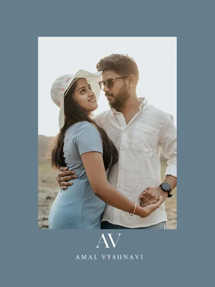 A stylish portrait of a couple on a rocky shore, framed in a cool blue border.