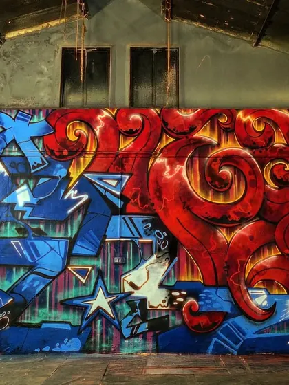 A high-energy mural created for a Red Bull dance event. The piece combines sharp, aggressive lettering with flowing organic shapes, capturing the dynamic clash of styles in a dance battle.