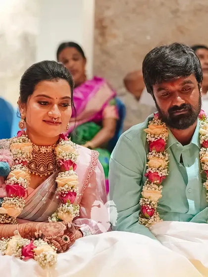 Kavya and her husband during the ceremony, her modern blouse adding a unique touch to the traditional setting.