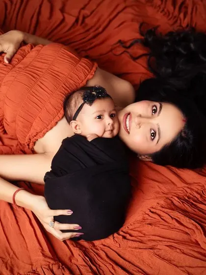 A beautiful overhead shot capturing an intimate moment between a mother and her newborn daughter.