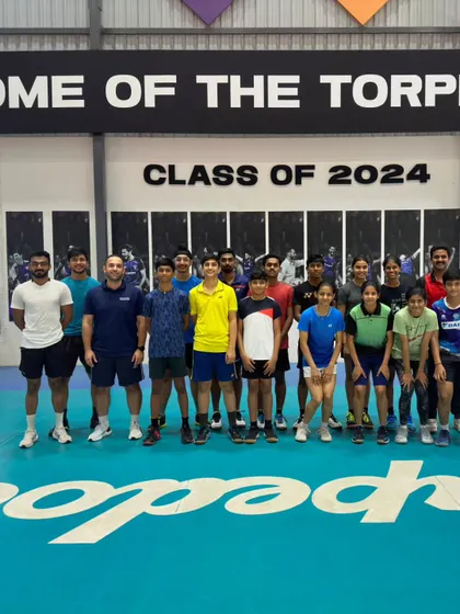 A group photo of our badminton players with the volleyball coaches after a successful cross-training session at the Home of the Torpedoes.