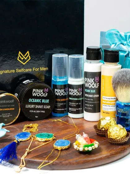 A comprehensive product shot of a Pink Woolf men's grooming and Rakhi gift set. This image clearly displays all the items included, making it an informative and attractive photo for e-commerce.