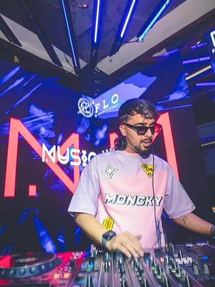 Another angle of me in my element, with vibrant visuals on the screen behind me. The visual production is an important part of the experience.