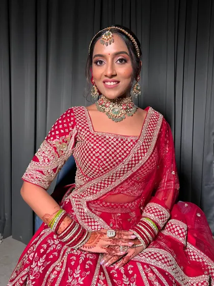 A full portrait of Apurva, showcasing her complete bridal look from head to toe.