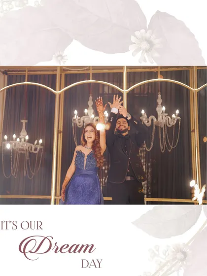 A joyful shot of the couple with their hands in the air, celebrating their "Dream Day" under a canopy of chandeliers.