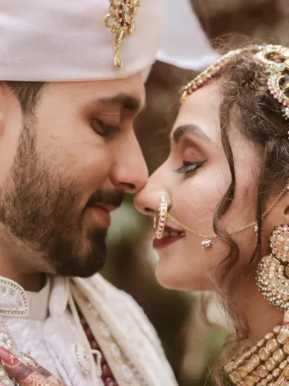 An intimate close-up, capturing the quiet moment just before a kiss. The focus is on the emotion and connection between the bride and groom.