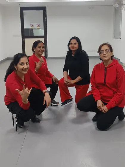 The "Mind Blowing Mahiya" ladies squad in their red and black outfits, looking powerful and ready to dance.