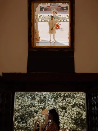 A creative 'first look' shot, where the bride and groom are captured in separate frames within the same image, building anticipation.