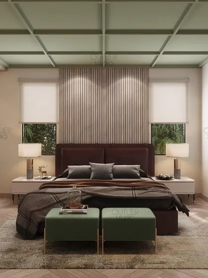 The perfect combination of green, beige, and brown tones creates a calming atmosphere in this bedroom. The coffered green ceiling and herringbone wood floor add unique architectural details.