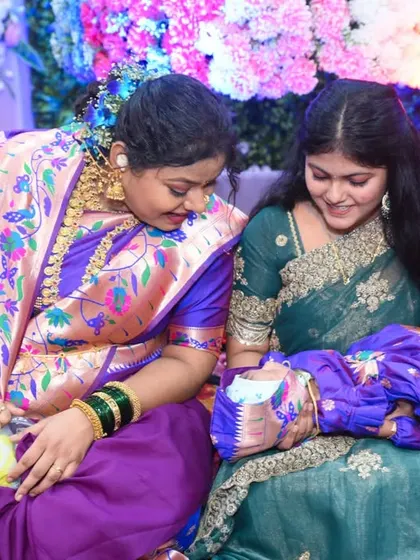 Family members admiring the newborn baby at the naming ceremony.