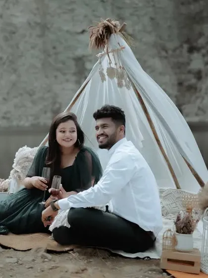 A wide shot of a romantic picnic setup by a quarry, showcasing the beautiful scenery and the thought we put into creating a unique pre-wedding experience.