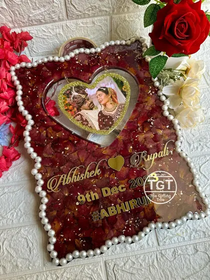 The deep red of the rose petals creates a rich, romantic background for the central photo and personalized text.