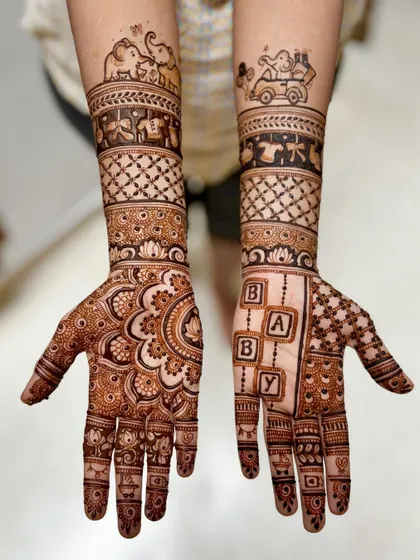 A lovely baby shower design combining traditional mandala work on the palm with playful baby elephants and toys on the forearm bands.