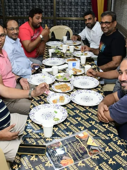 A table of friends enjoying their Iftar feast.
