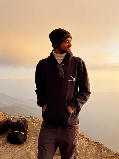 A portrait of our trip captain against the golden hour glow at a Himalayan viewpoint. They are always there to guide you and ensure you have a memorable experience.