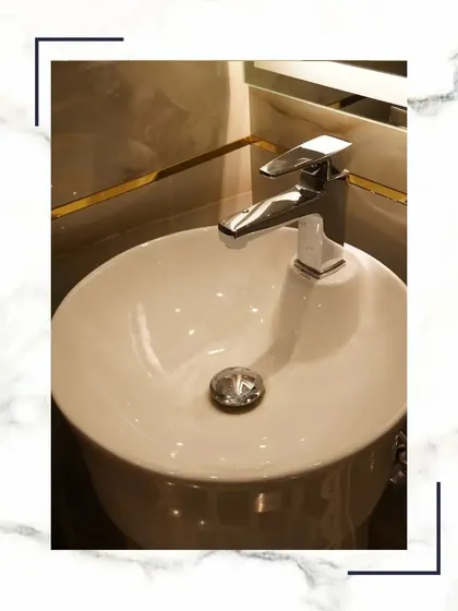 Sophisticated simplicity. This close-up shows a modern vessel sink with a sleek chrome faucet, a detail that represents our focus on both aesthetics and comfort.