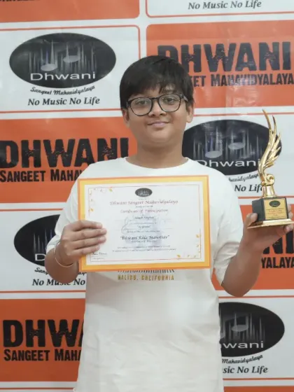 A smiling student proudly holds his certificate and trophy. Our award ceremony is a highlight of the annual function, boosting morale and recognizing dedication.