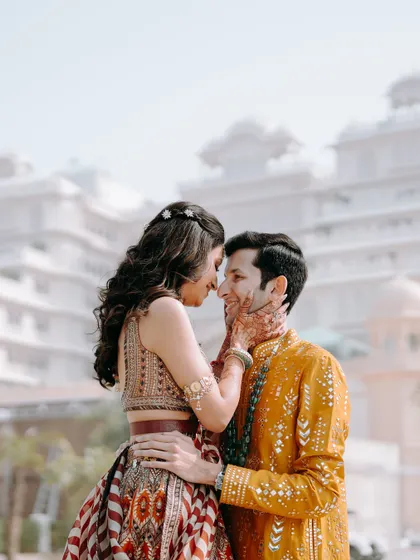 A romantic portrait of the couple after their haldi ceremony, with the bride gently touching the groom's face against the backdrop of the Anantara Jaipur.