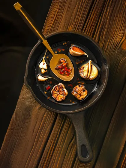 A top-down shot of a cast-iron pan with a chili garlic marinade, showcasing the rich colors and ingredients.