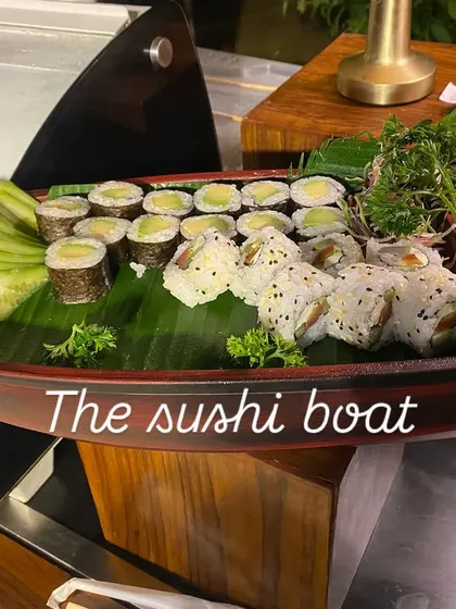 We bring authentic global flavors to your event, like this beautifully arranged sushi boat. It's a perfect example of our Pan-Asian offerings, featuring a variety of fresh sushi and maki rolls presented as a culinary centerpiece.