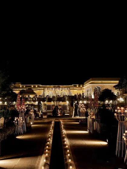 The entire venue glowing with the warmth of candles and strategic lighting, transforming a large open space into an intimate and magical setting.