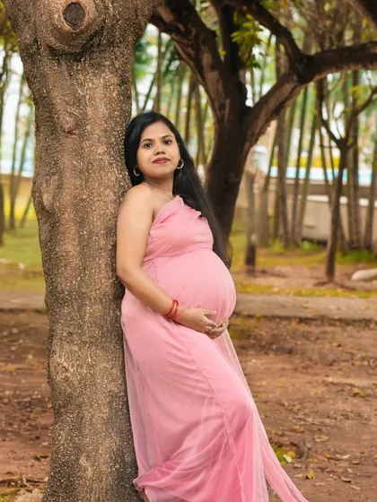 A serene solo portrait of an expectant mother in a beautiful park. The natural light and peaceful surroundings perfectly complement the beauty of this special time.