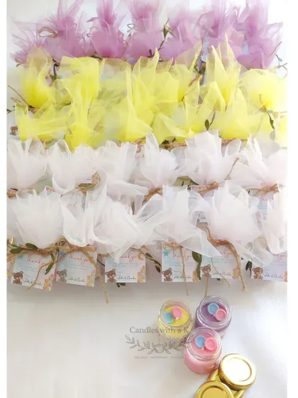 The full set of baby shower favors, beautifully wrapped in pastel-colored net, ready for the celebration.