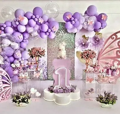Celebrating a magical first birthday with a whimsical butterfly theme. This enchanting setup in shades of purple features a stunning dessert table, custom butterfly wing backdrops, and sparkling details to make the milestone unforgettable.