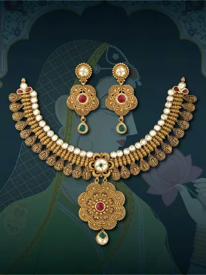 Each piece tells a story. This antique necklace set is adorned with red and green stones, offering a classic design with a touch of colour that appeals to a wide audience.