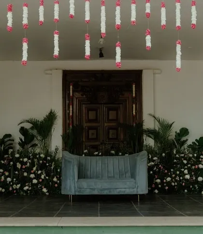 Another view of the Bhaat ceremony stage, with a comfortable sofa for seating.