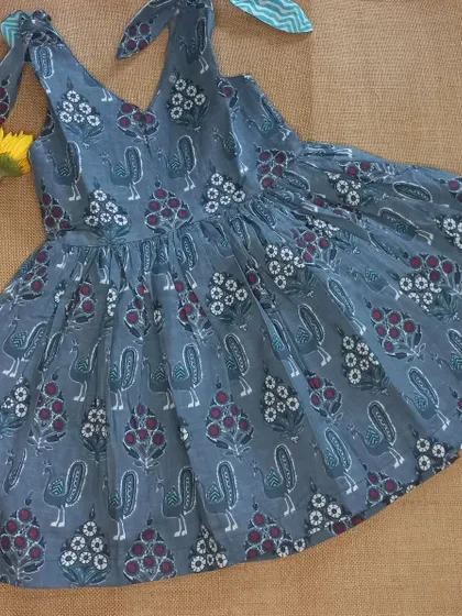 I love incorporating traditional Indian crafts into my designs. This breezy frock features a beautiful block print with birds and flowers, and the tie-up shoulders make it adjustable as your child grows. It's a simple, timeless piece made for sunny days.